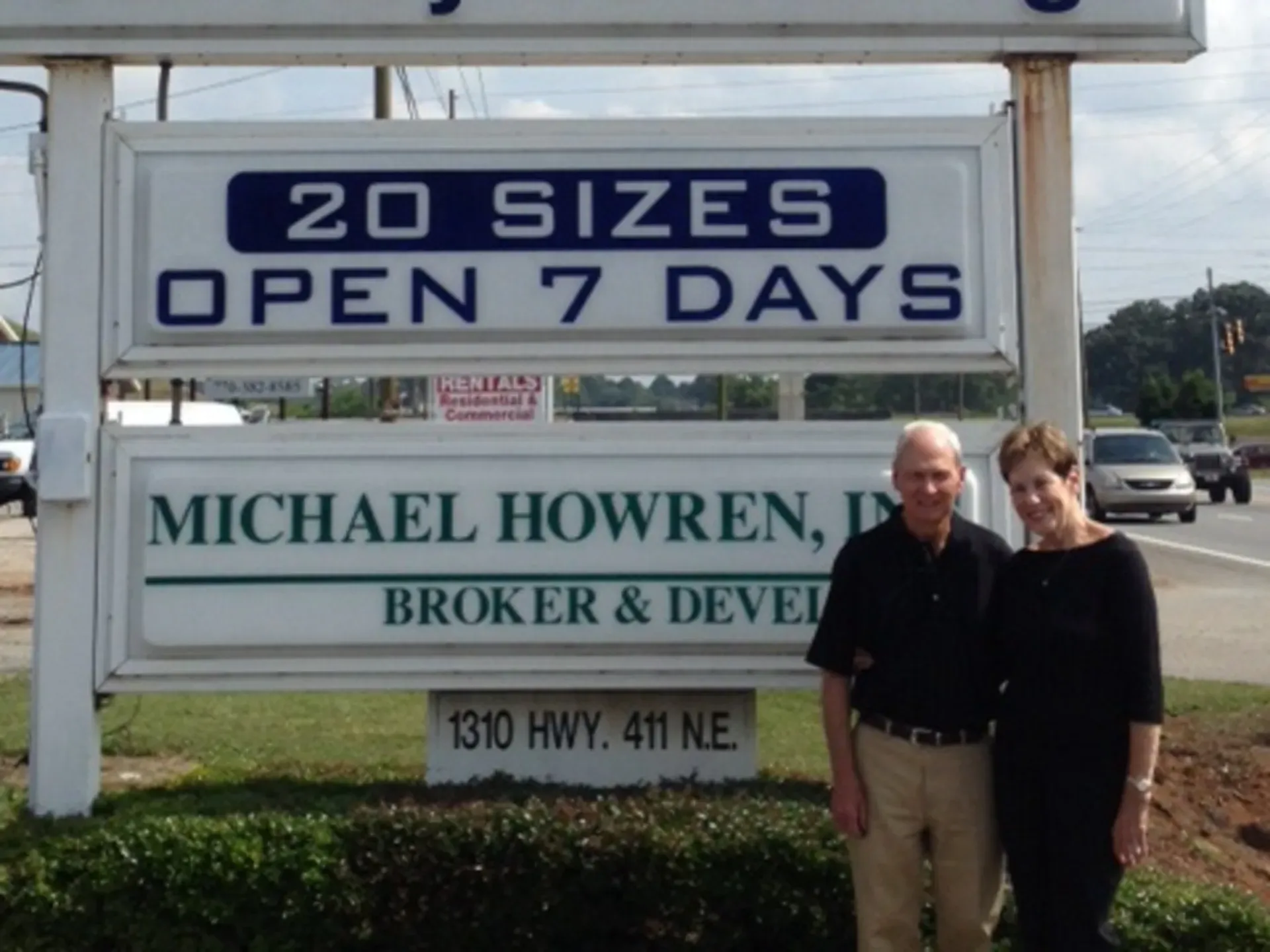 Michael Howren and his wife standing in front of The Storage Key monument sign on Highway 411 in Cartersville, Georgia.
